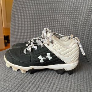 Little boys Under Armour baseball cleats
